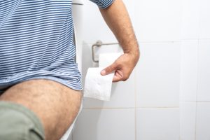 Hand taking toilet paper